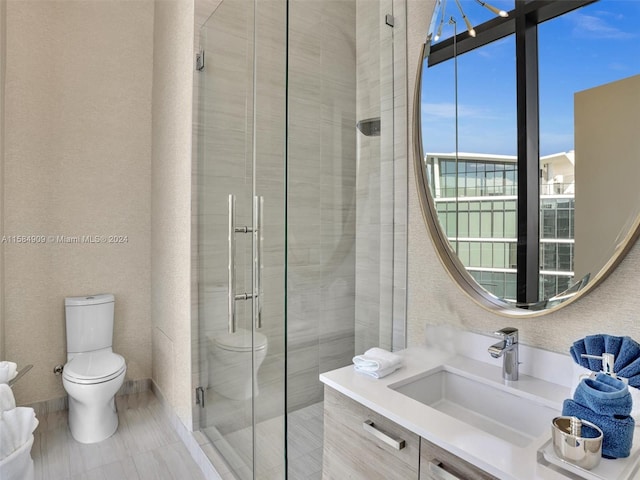 bathroom with walk in shower, vanity, and toilet