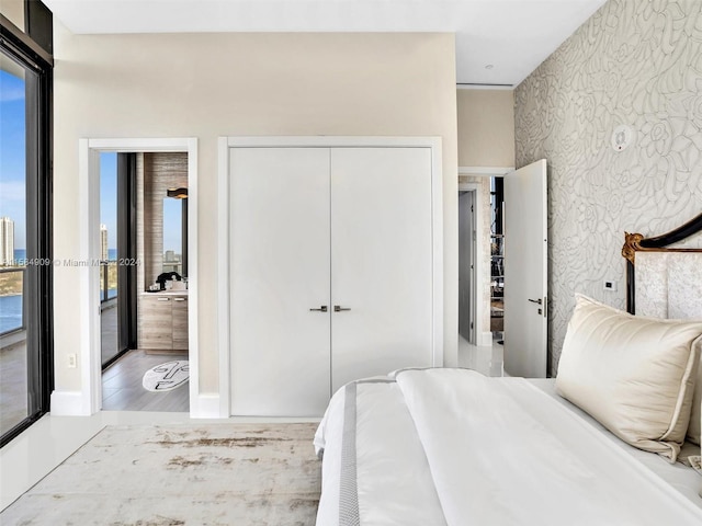 bedroom featuring multiple windows and hardwood / wood-style flooring