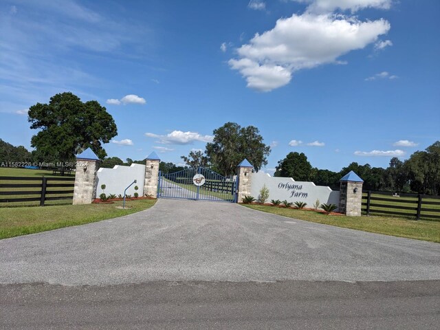 7787 NW 150th Ave, Ocala, FL 32668 - view of asphalt driveway with a gate and a gated entry