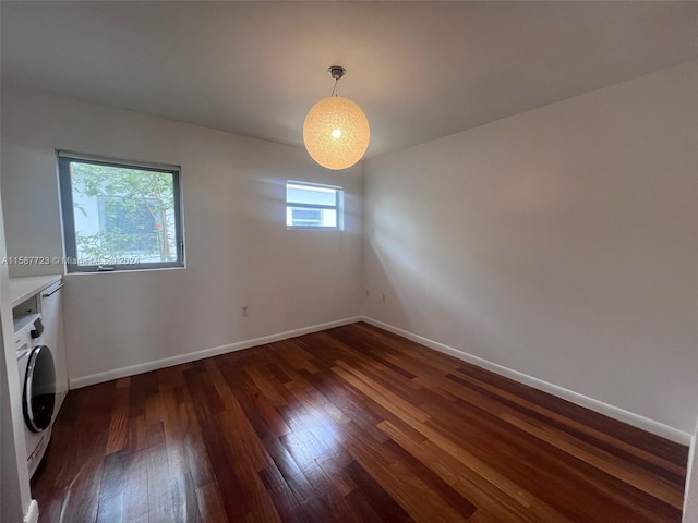 washroom featuring washer / dryer, dark hardwood / wood-style flooring, and a wealth of natural light