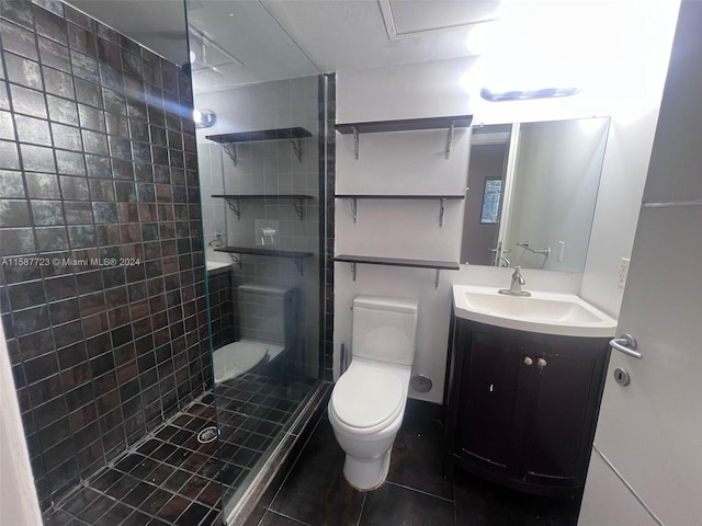 bathroom featuring a shower with door, vanity, tile patterned flooring, and toilet