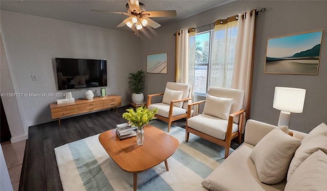 living room with ceiling fan, hardwood / wood-style flooring, and a textured ceiling