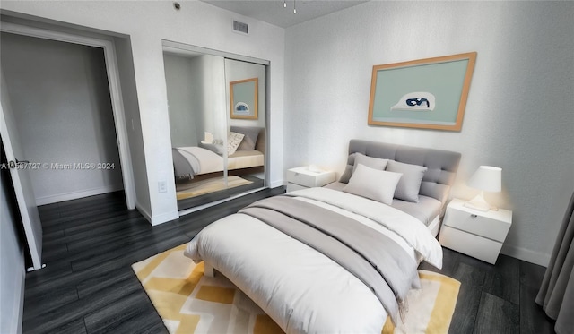 bedroom featuring a closet and dark hardwood / wood-style flooring