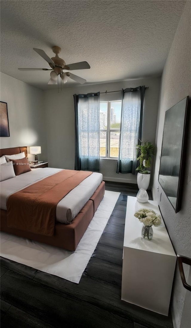 bedroom featuring a textured ceiling, ceiling fan, and hardwood / wood-style flooring