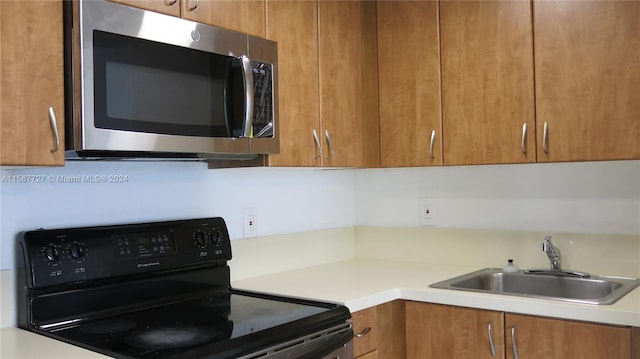 kitchen with black range with electric cooktop and sink