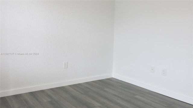 spare room with dark hardwood / wood-style flooring