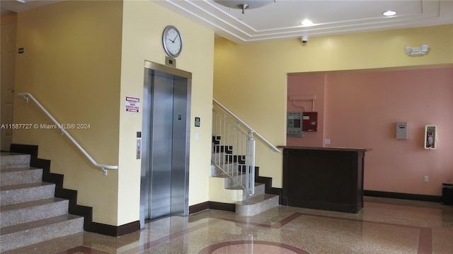 interior space featuring a high ceiling and elevator