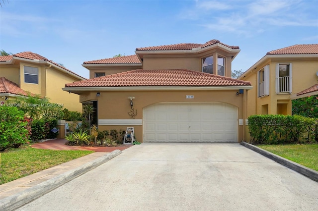 mediterranean / spanish house featuring a garage