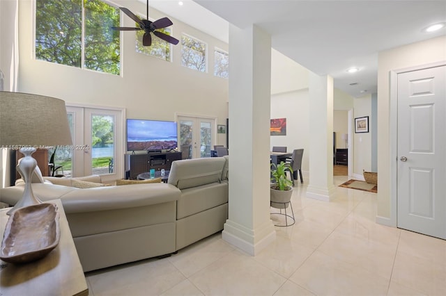 living room featuring french doors, ceiling fan, and light tile floors