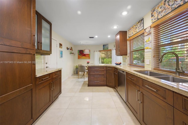 kitchen featuring kitchen peninsula, dishwasher, light stone countertops, sink, and light tile floors