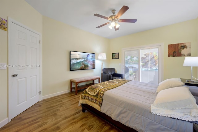 bedroom with ceiling fan, hardwood / wood-style flooring, and access to exterior