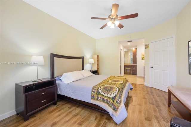 bedroom featuring connected bathroom, light wood-type flooring, and ceiling fan