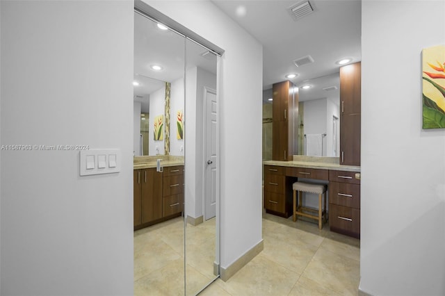 bathroom featuring tile flooring and vanity