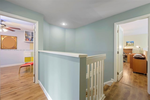 corridor with hardwood / wood-style floors