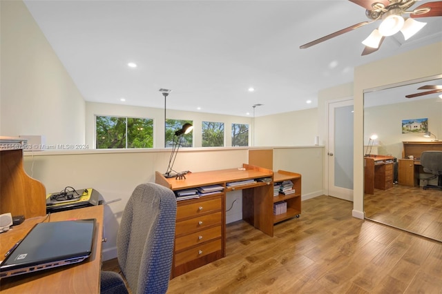 home office with hardwood / wood-style floors and ceiling fan