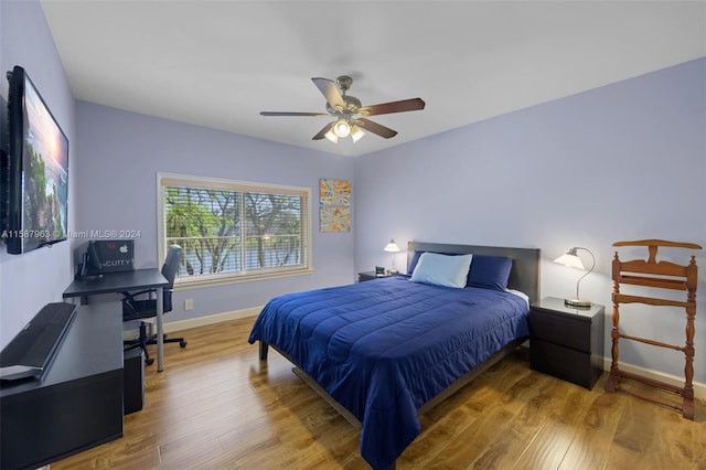 bedroom with ceiling fan and hardwood / wood-style flooring