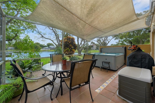 view of patio featuring a hot tub and a water view