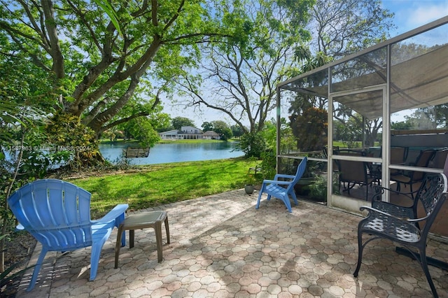 view of patio with glass enclosure and a water view