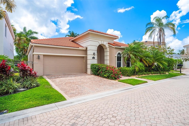 mediterranean / spanish-style home featuring a garage