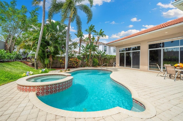 view of pool with a patio area and an in ground hot tub