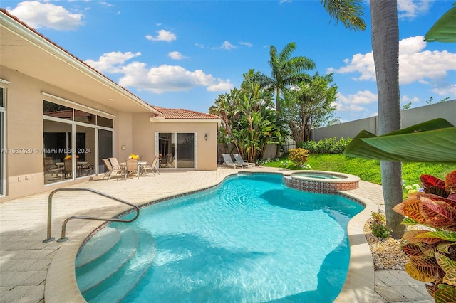 view of swimming pool with a patio and an in ground hot tub