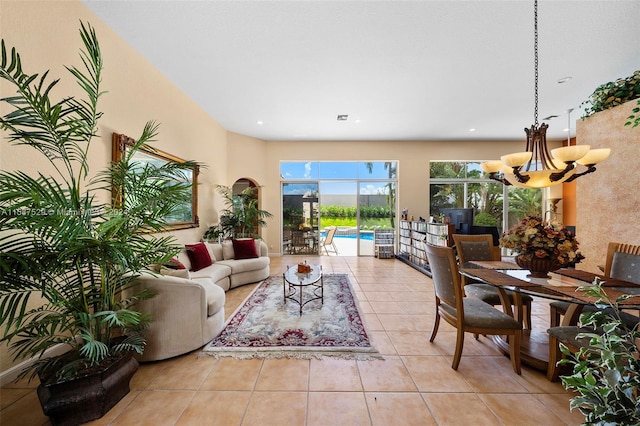 living room featuring light tile patterned flooring and a chandelier