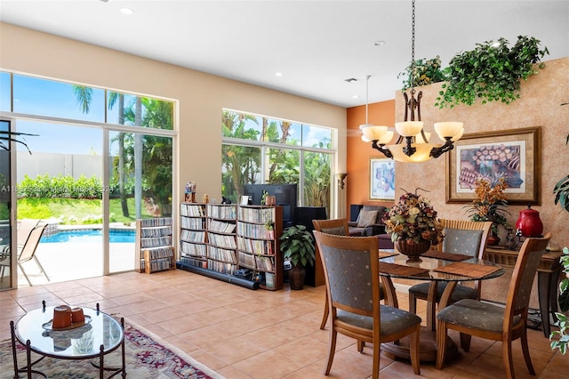 tiled dining area featuring an inviting chandelier