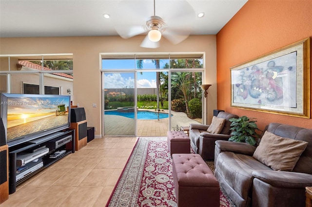 tiled living room with a wealth of natural light and ceiling fan