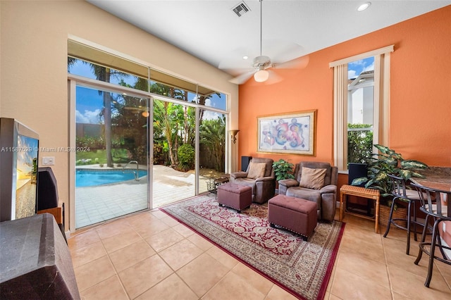 living room featuring light tile patterned floors and ceiling fan