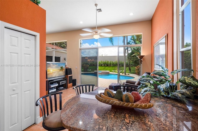 tiled dining room with ceiling fan