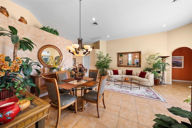 tiled dining room featuring an inviting chandelier