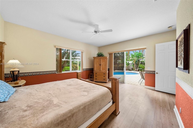 bedroom featuring a textured ceiling, access to exterior, wood-type flooring, and ceiling fan