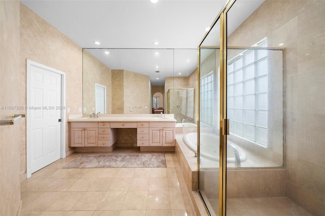 bathroom with vanity, tile walls, separate shower and tub, and tile patterned flooring