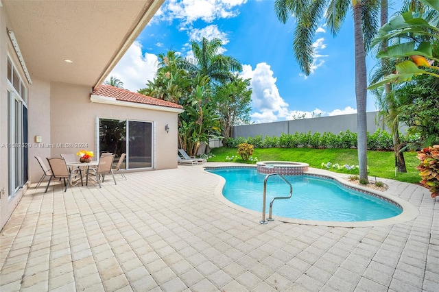 view of swimming pool with an in ground hot tub and a patio