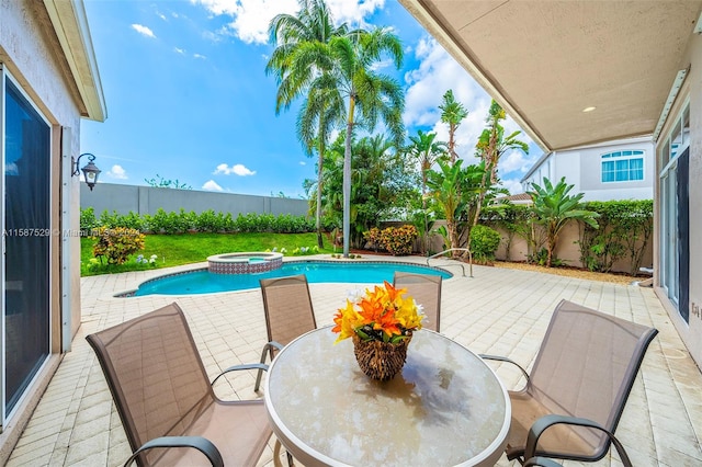 view of pool with a patio and an in ground hot tub