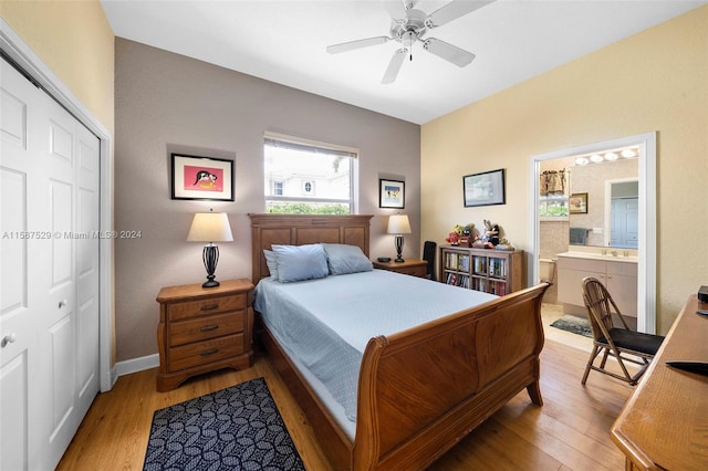 bedroom featuring light hardwood / wood-style floors, a closet, ensuite bathroom, and ceiling fan