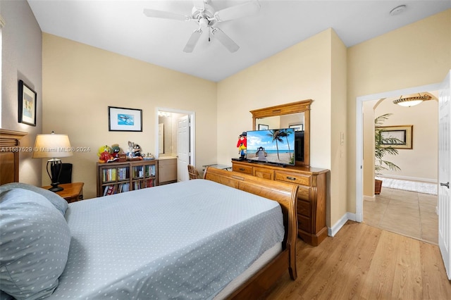 bedroom featuring connected bathroom, light hardwood / wood-style flooring, and ceiling fan