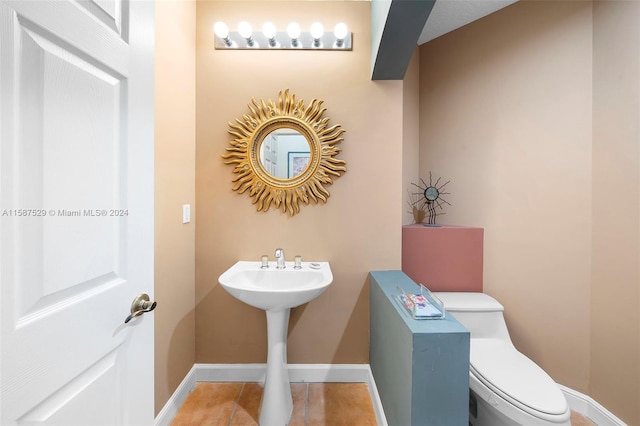 bathroom featuring toilet and tile patterned flooring