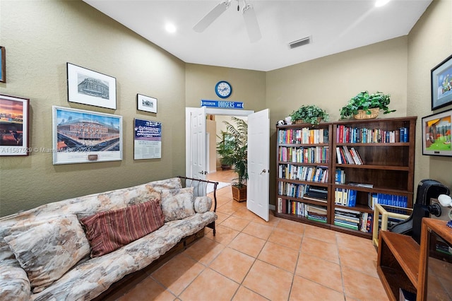 living area featuring ceiling fan and light tile patterned floors