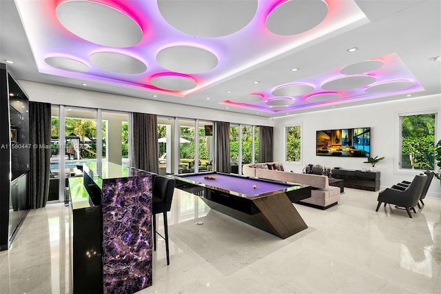 game room featuring a raised ceiling and billiards