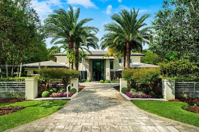 exterior space with fence private yard, decorative driveway, and stucco siding