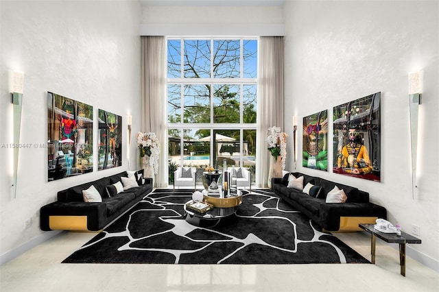 living room featuring a towering ceiling