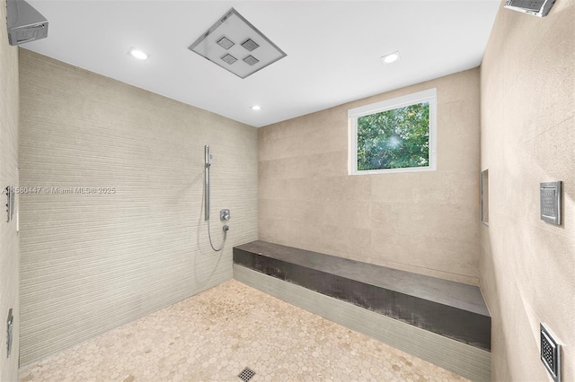 bathroom with recessed lighting and a tile shower