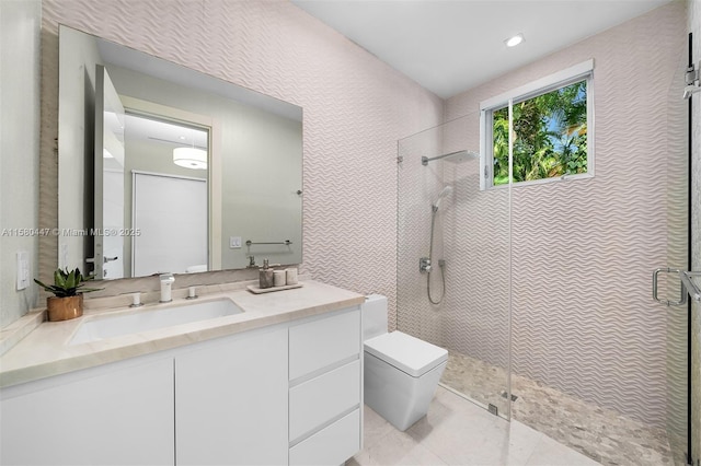 bathroom featuring tile patterned floors, a shower with door, vanity, and toilet