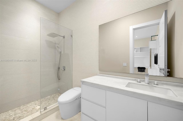 full bath with a tile shower, toilet, and vanity