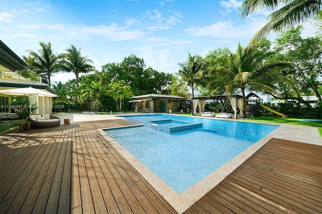 view of swimming pool featuring an in ground hot tub and a wooden deck