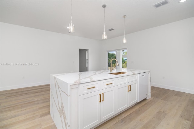 kitchen with a kitchen island with sink, white cabinets, sink, light hardwood / wood-style flooring, and white dishwasher