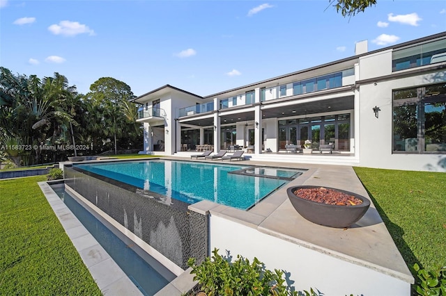 view of swimming pool featuring a patio area and a lawn