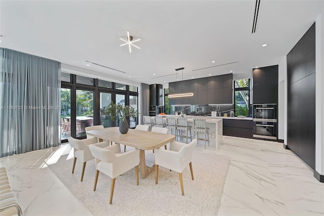 tiled dining space featuring expansive windows