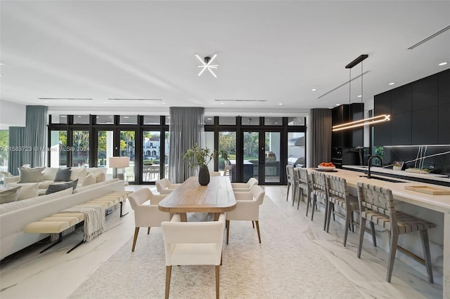 dining room featuring a healthy amount of sunlight, sink, and french doors